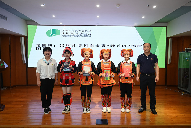 廣西師范大學(xué)出版社集團副總裁、工會(huì )主席莫曲波（右一）代表出版社向金秀“獨秀班”同學(xué)贈送圖書(shū)（李顯楊攝）.jpg